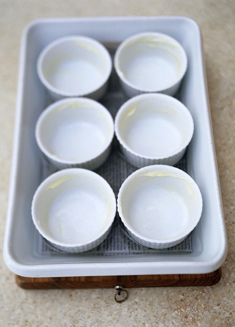 Six soufflé dishes in bain-marie