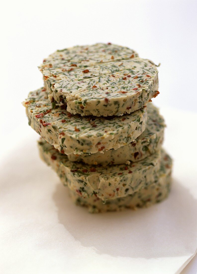 Slices of herb butter in a pile