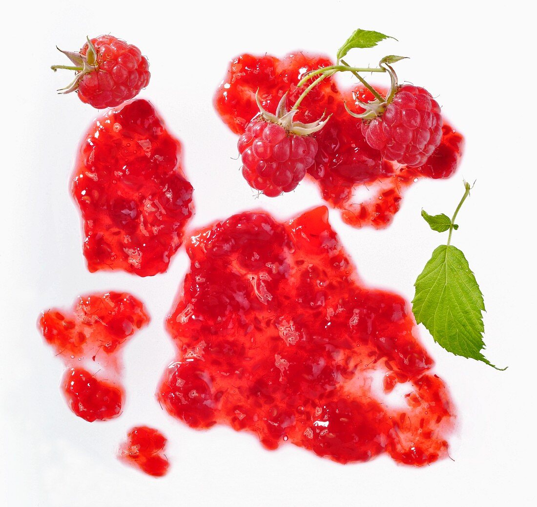 Blob of raspberry jam with fresh raspberries