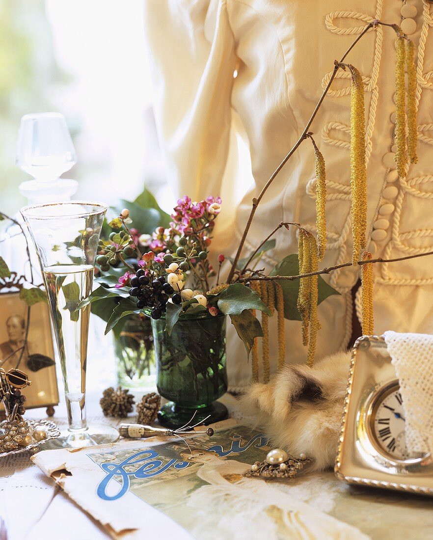 Nostalgic still life with flowers, jewellery & champagne glass