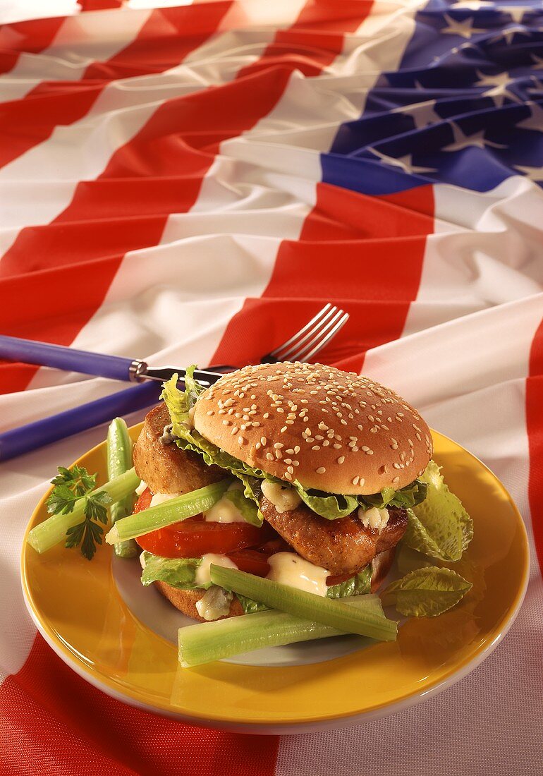 Burger with pork fillet, vegetables & mayonnaise on US flag
