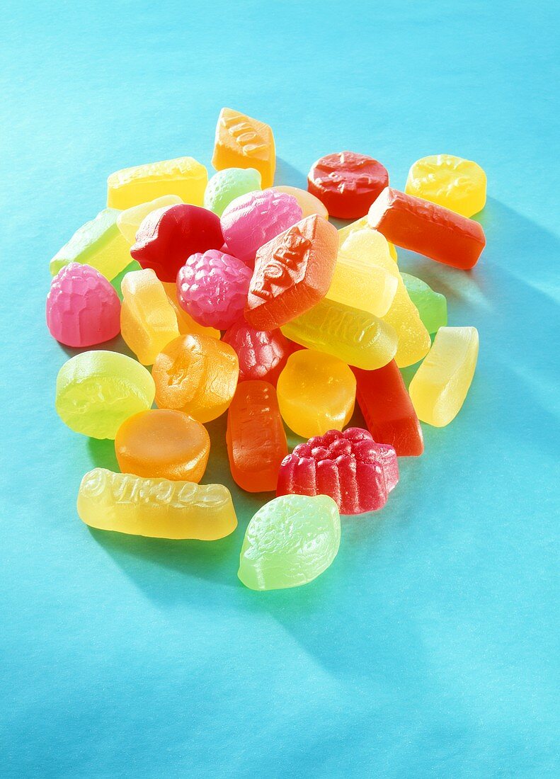 Colourful fruit gums on turquoise background