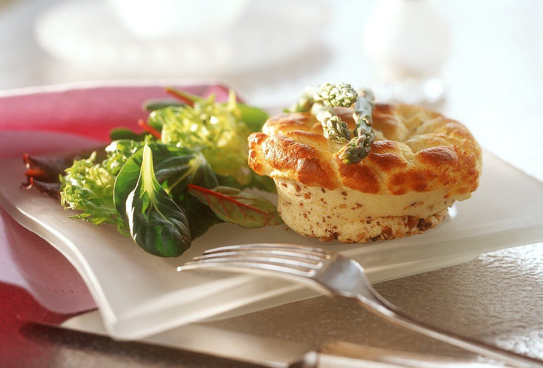 Small cheese and nut soufflé on salad