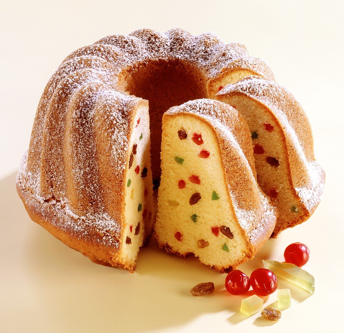 Ring cake with candied fruit, a piece cut