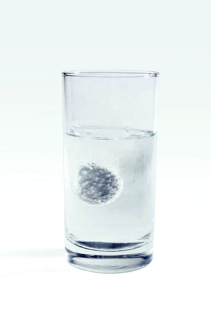 Soluble aspirin tablets in glass of water