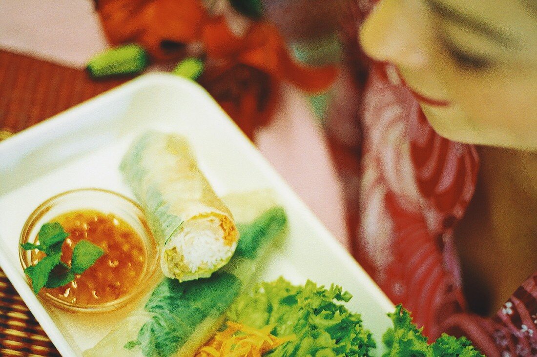 European woman eating Vietnamese spring rolls (surreal)