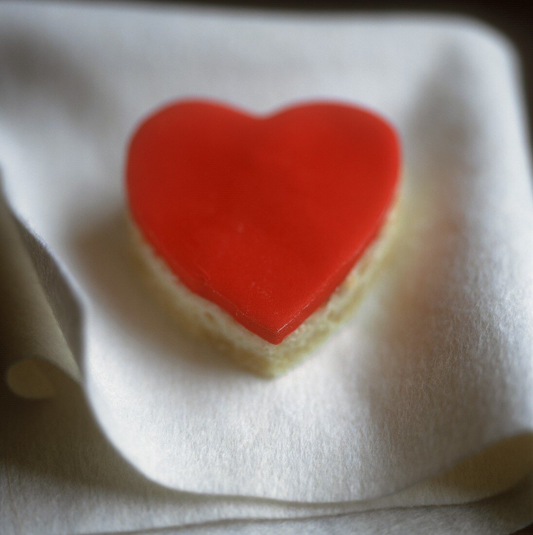 Heart-shaped sponge cake with red icing
