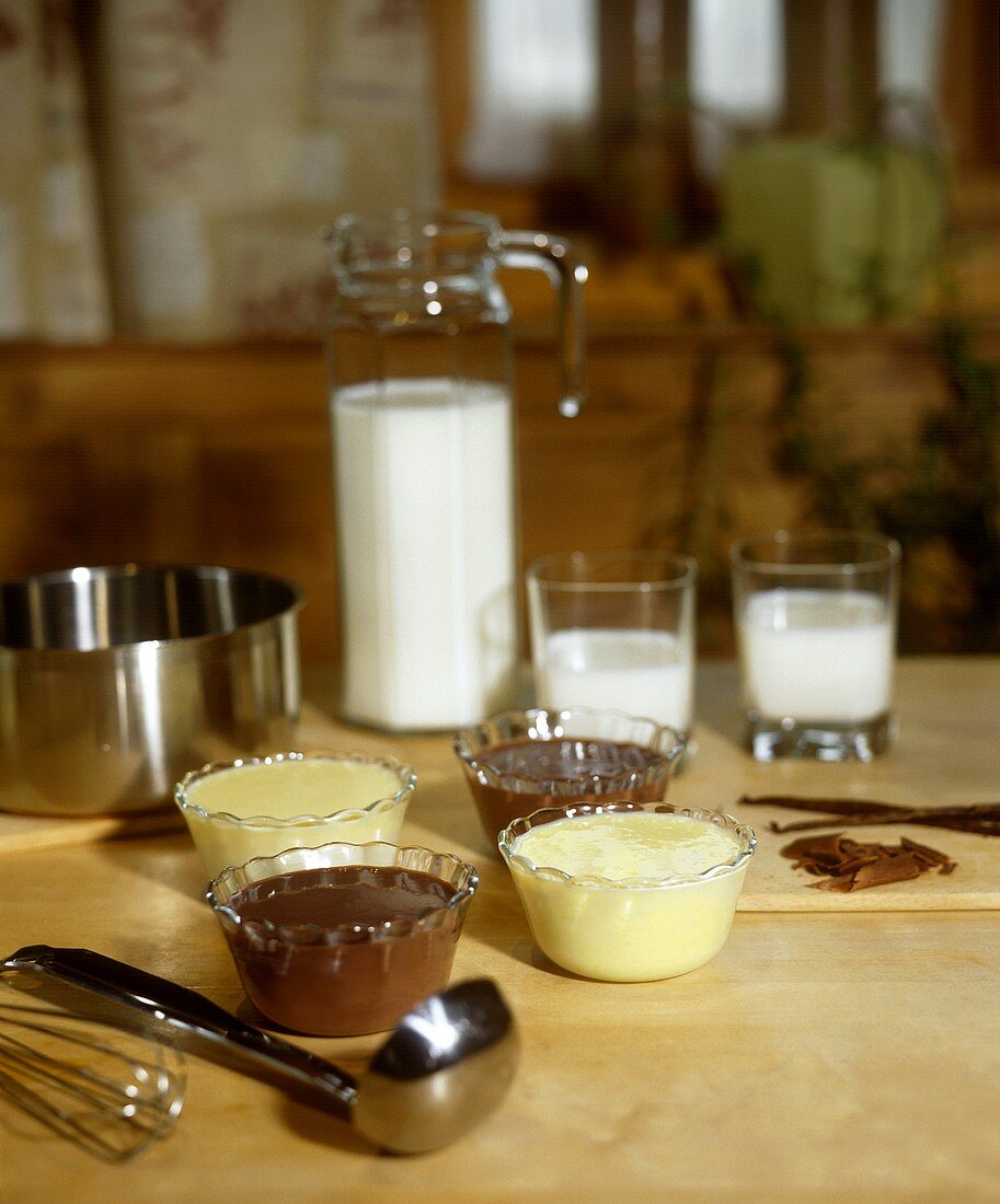 Bowls of chocolate and vanilla blancmange on kitchen table