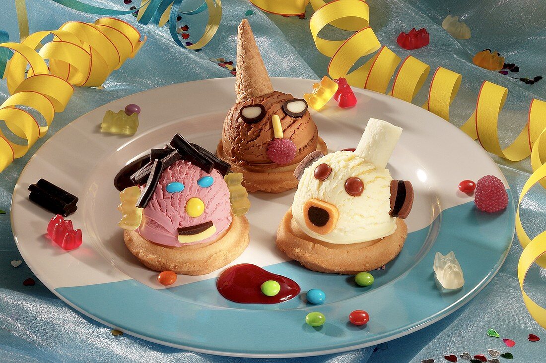 Three amusingly decorated scoops of ice cream on plate 