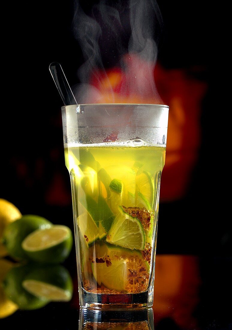 Hot caipirinha in glass (winter drink)
