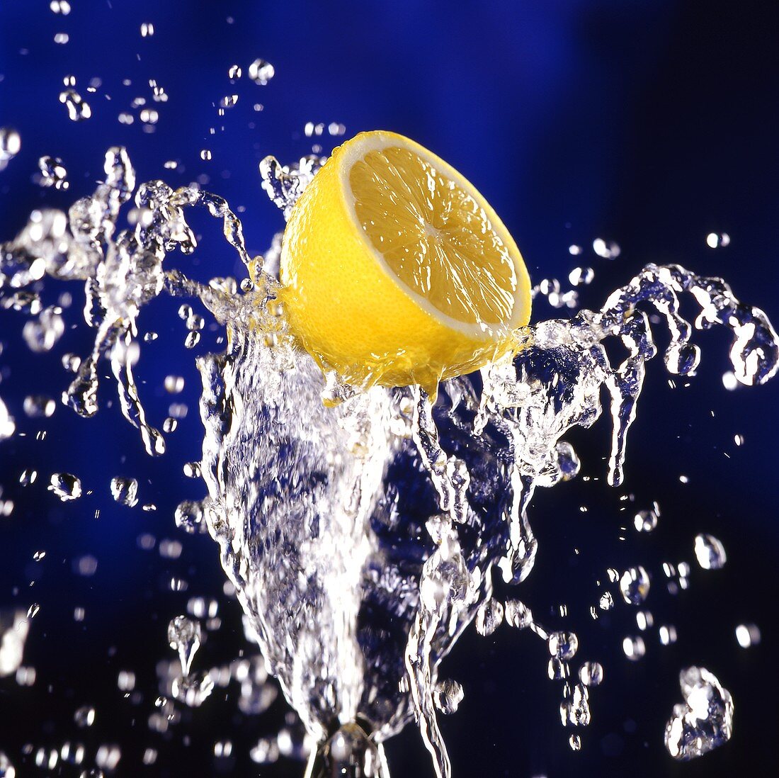 Half a lemon on splashing water