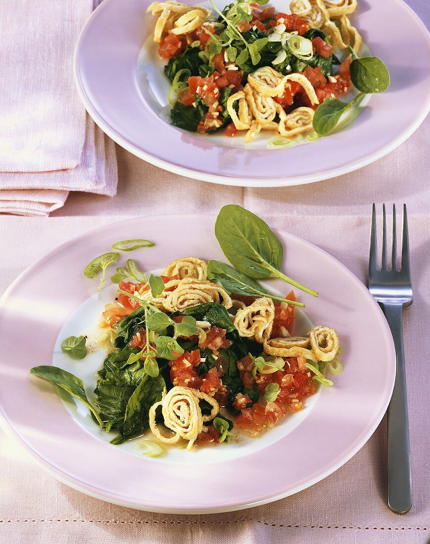 Spinach with tomato sauce and strips of pancake