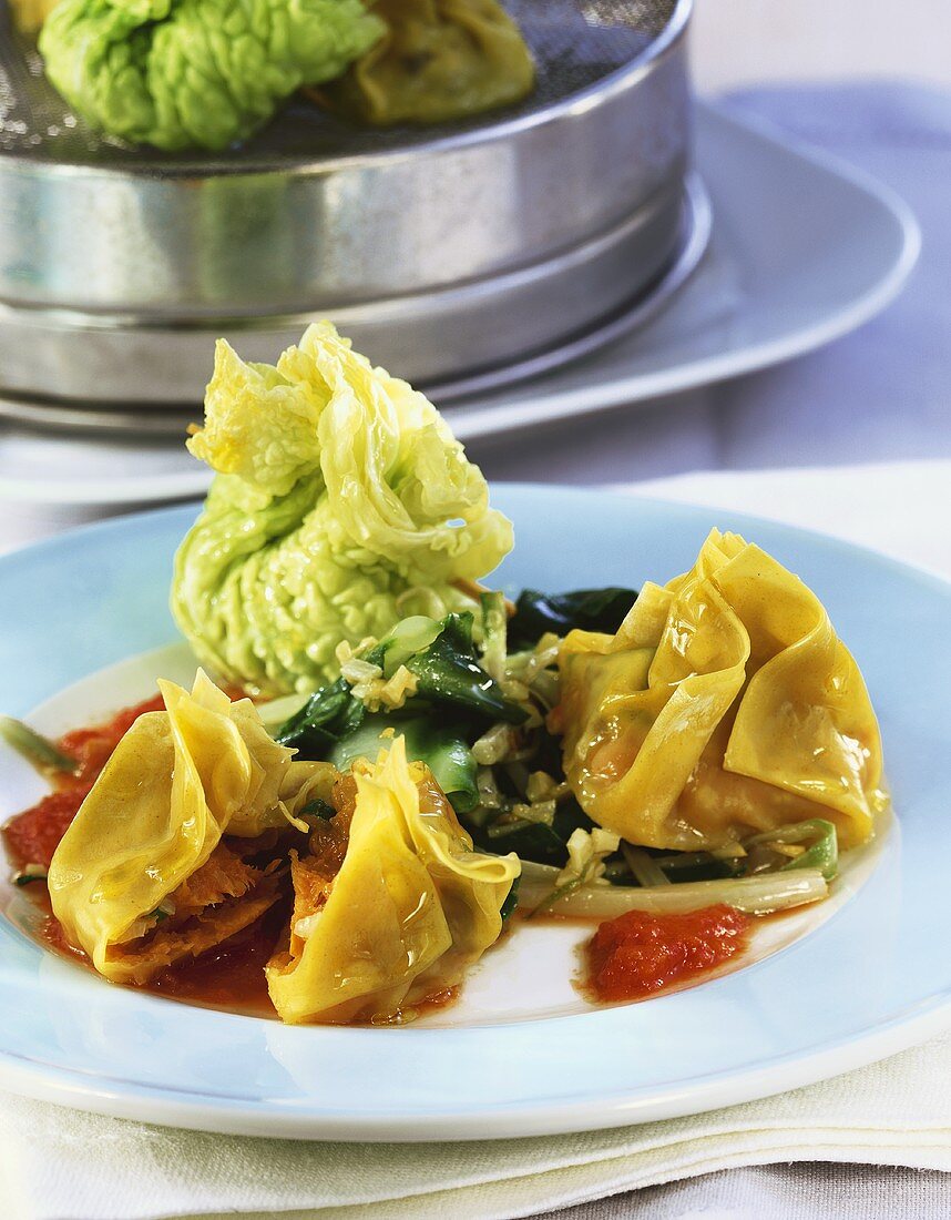 Pasta parcels and savoy parcels with tomato sauce