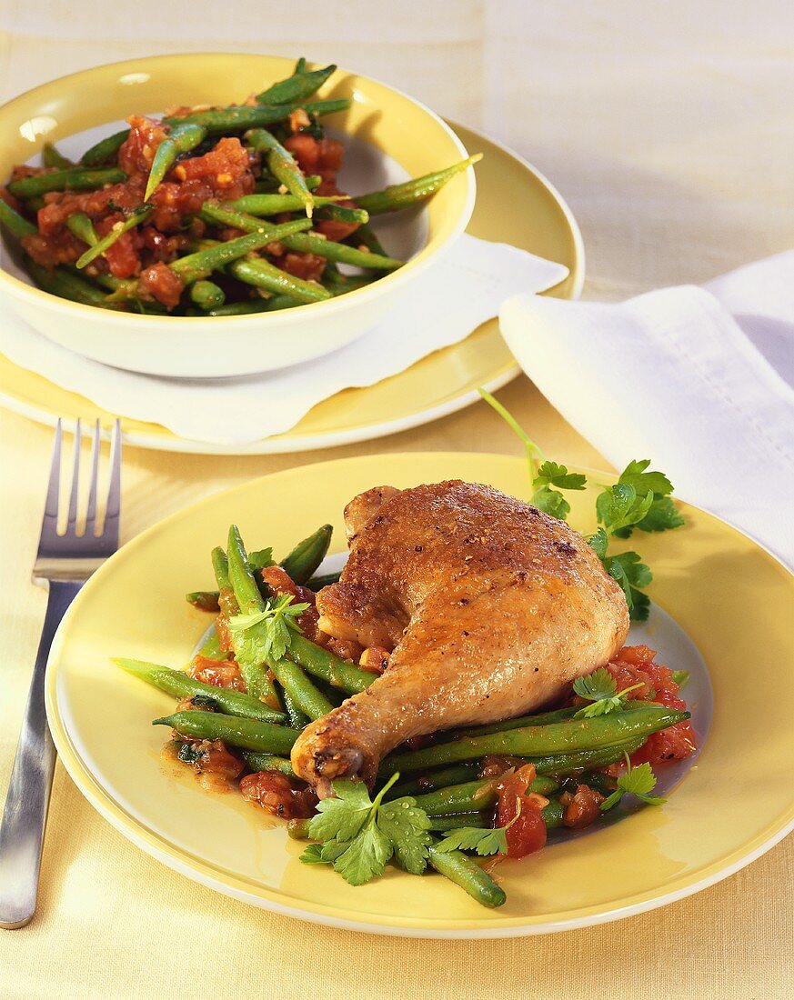 Chicken leg on green beans with tomato sauce