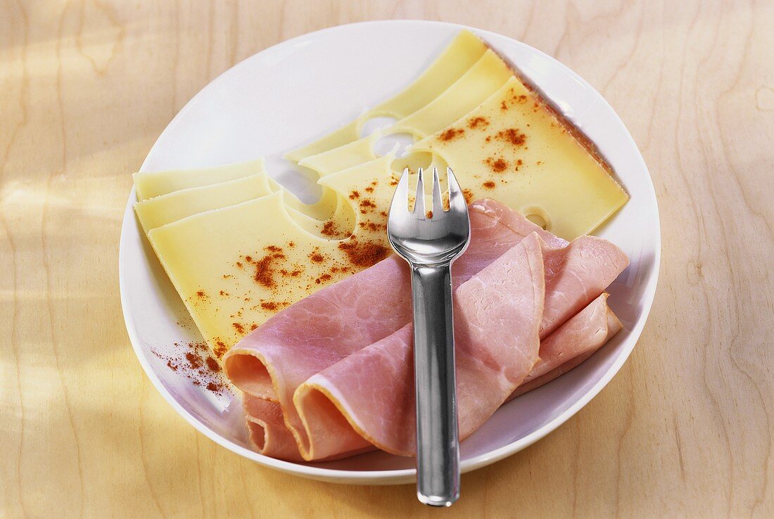 Plate of ham and cheese with paprika