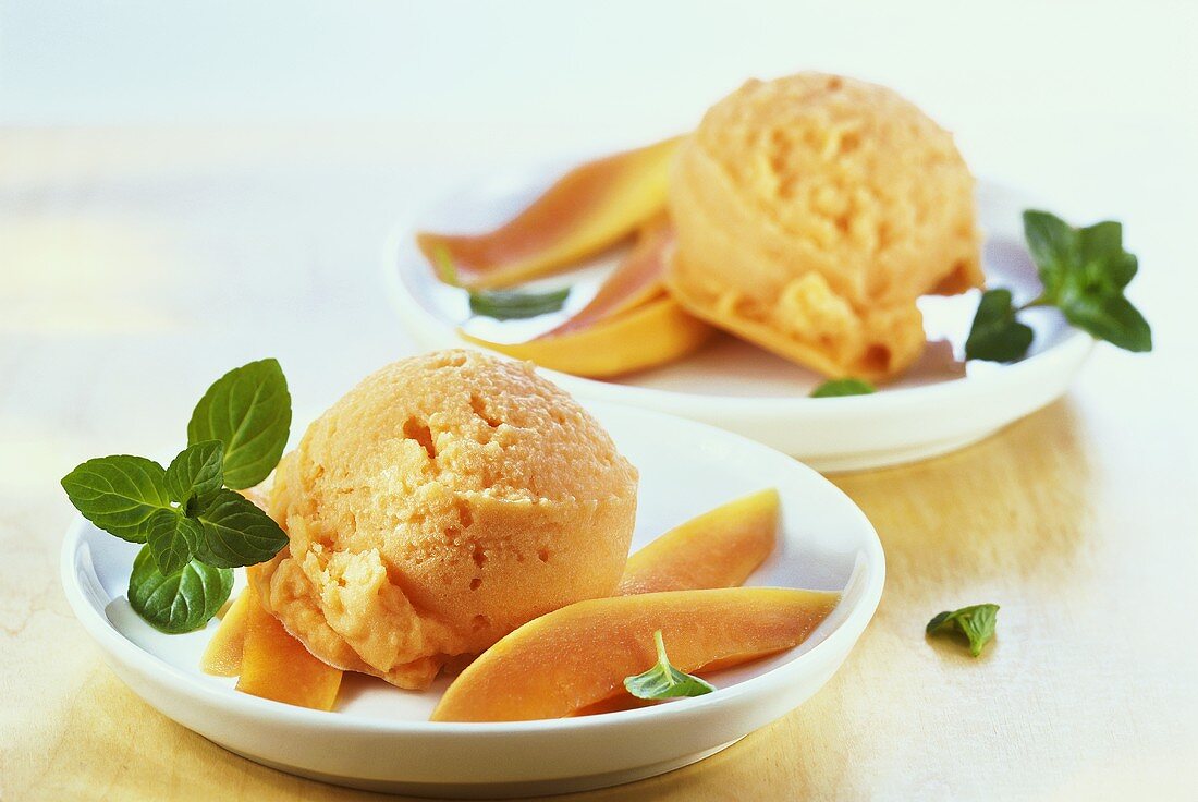 Coconut and papaya ice cream with mint leaves