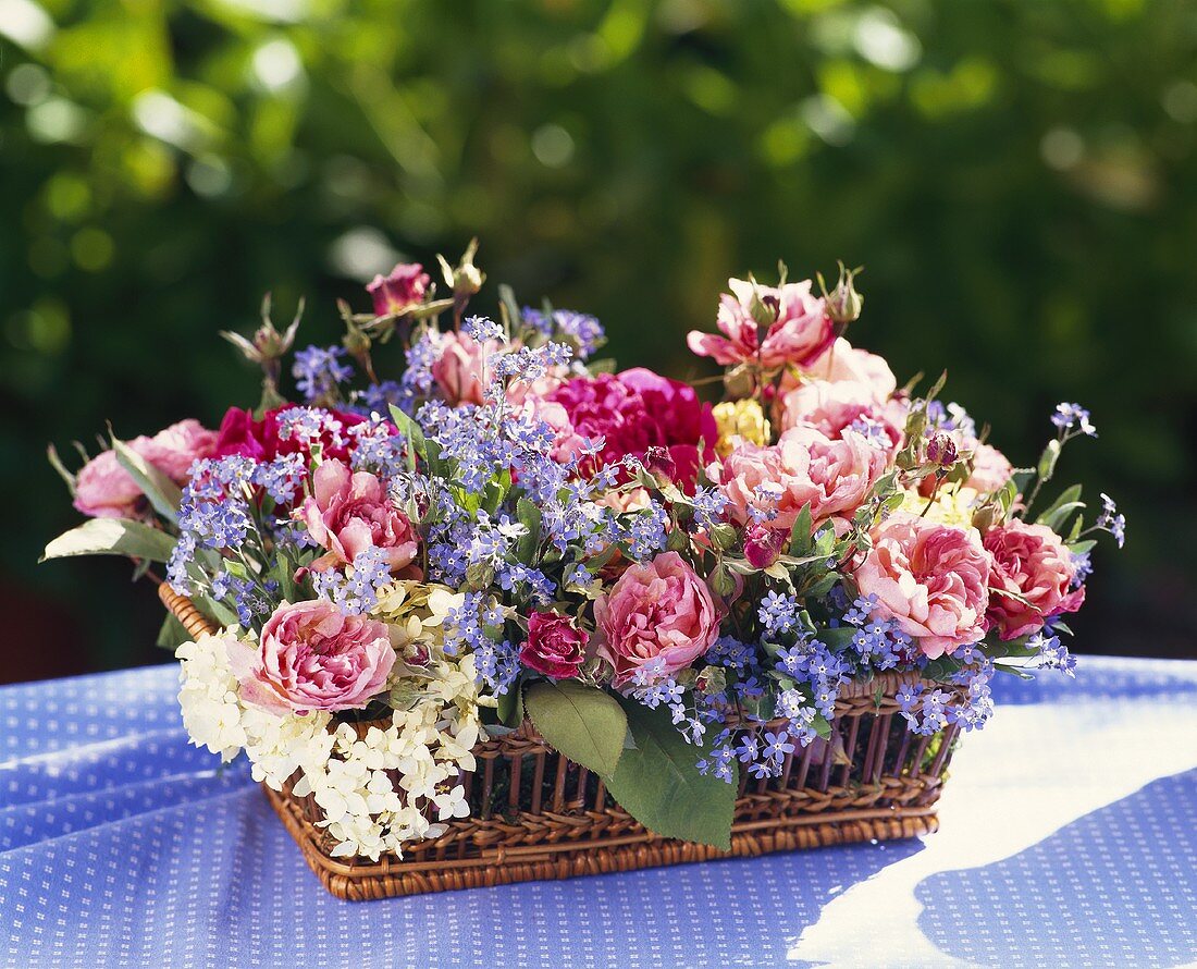 Silk flower arrangement in basket