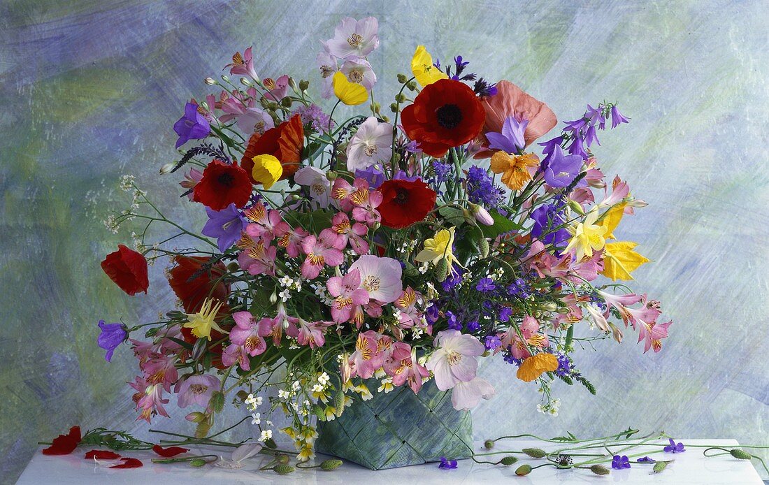 Summer bouquet of poppies, bluebells, Peruvian lily etc.