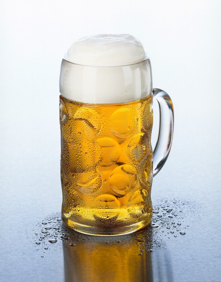 A tankard of beer with head of foam