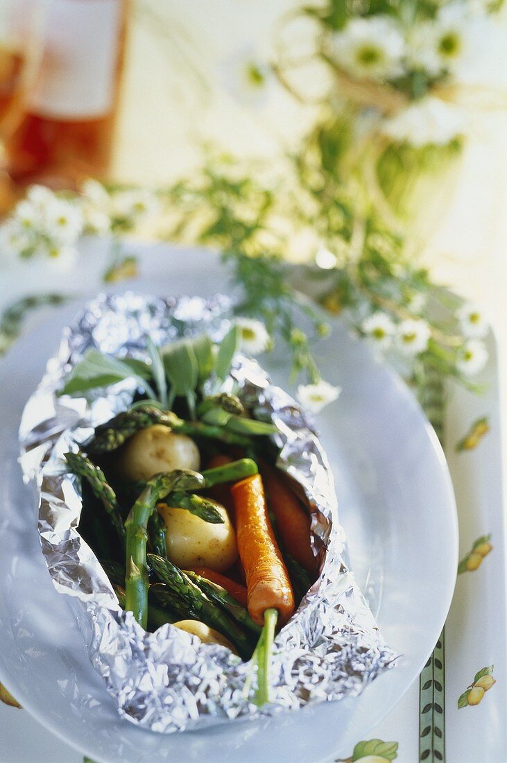 Spring vegetables steamed in aluminium foil