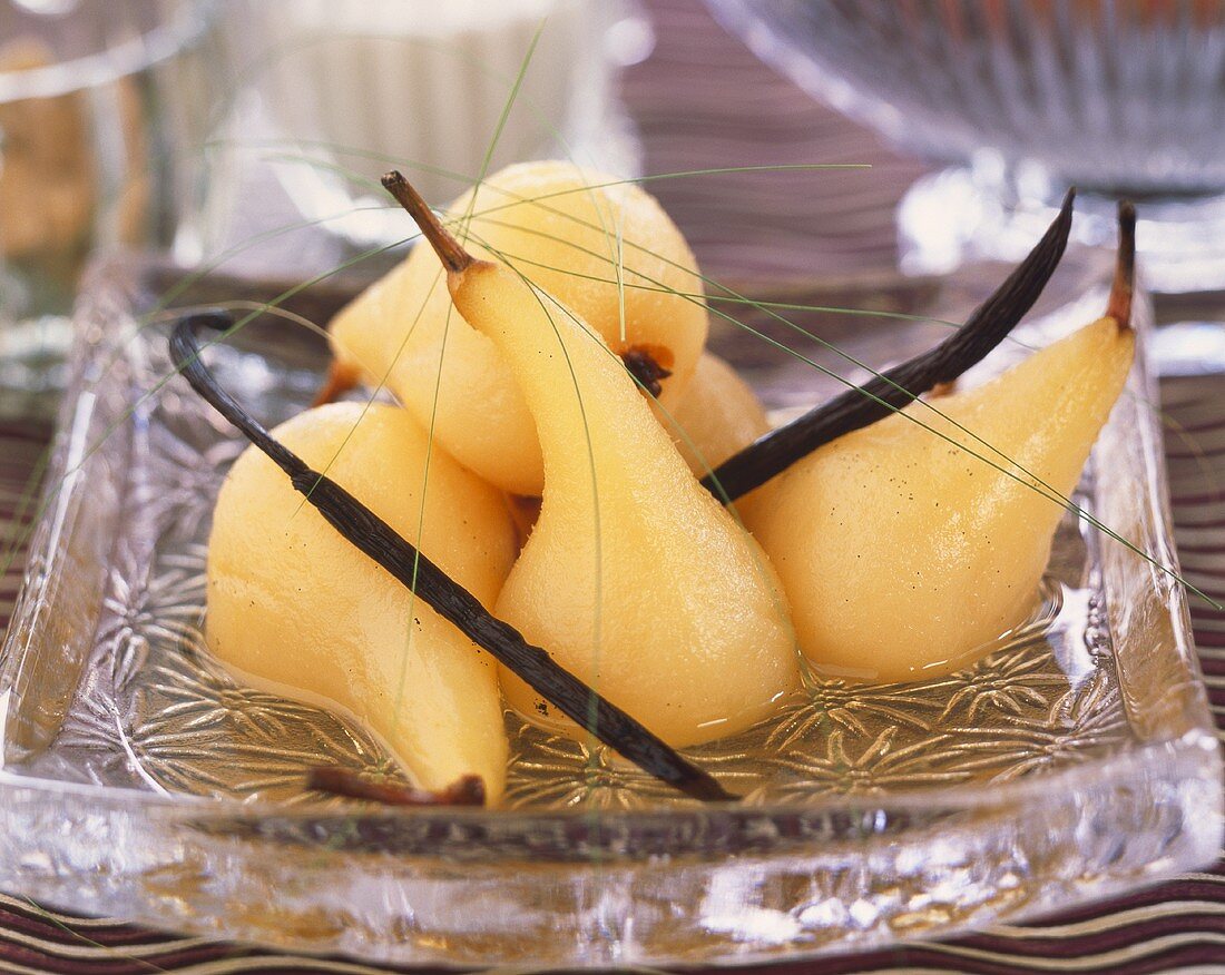 Poached pears in syrup with vanilla pods