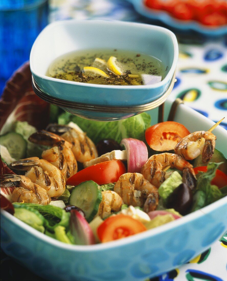 Grilled shrimp kebabs on Greek salad
