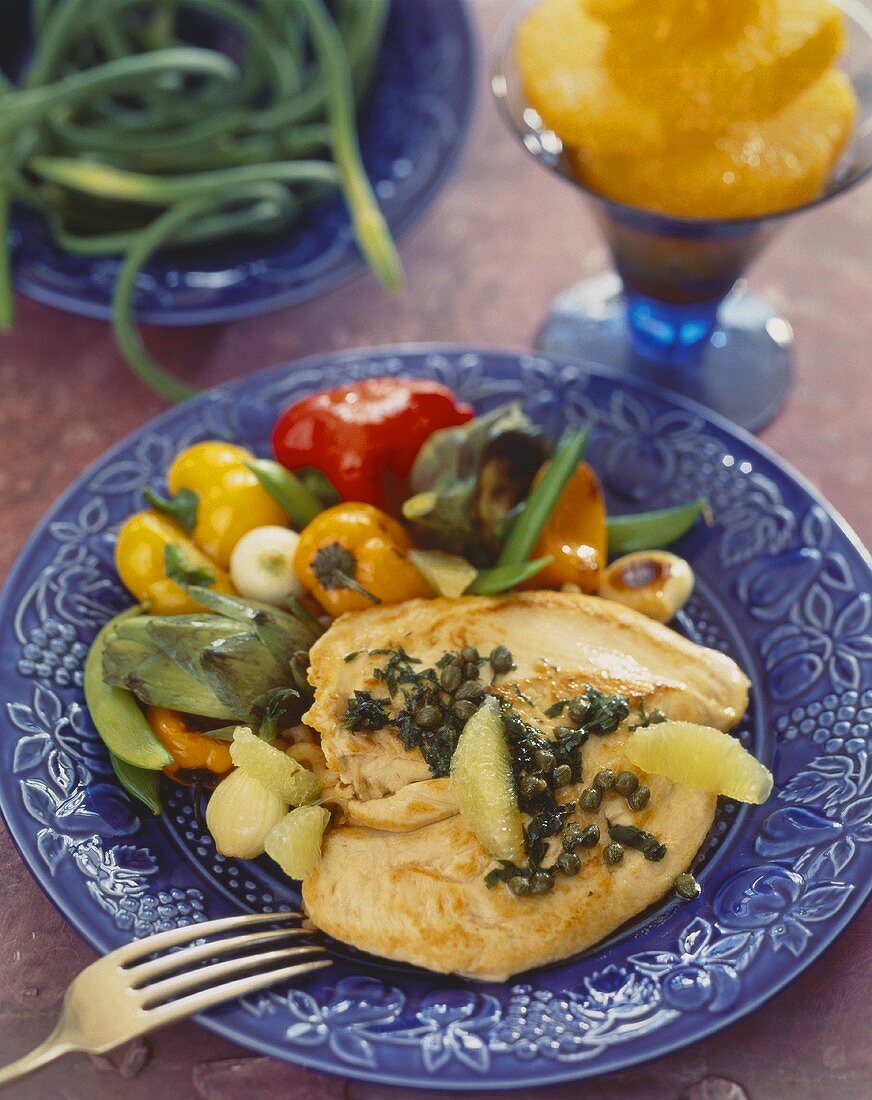 Chicken breast with lemon and capers, garden vegetables