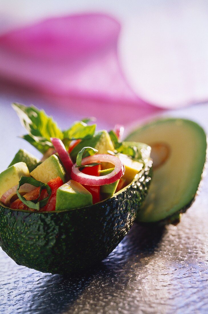 Avocado and tomato salad served in a hollowed-out avocado