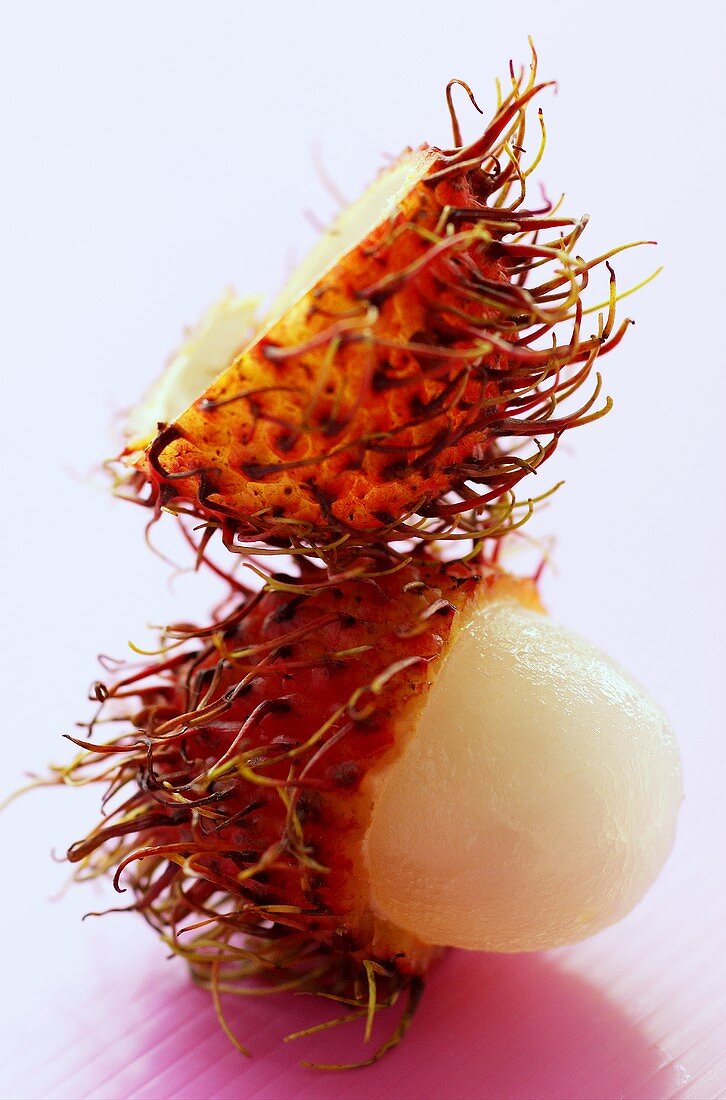 A rambutan with opened skin