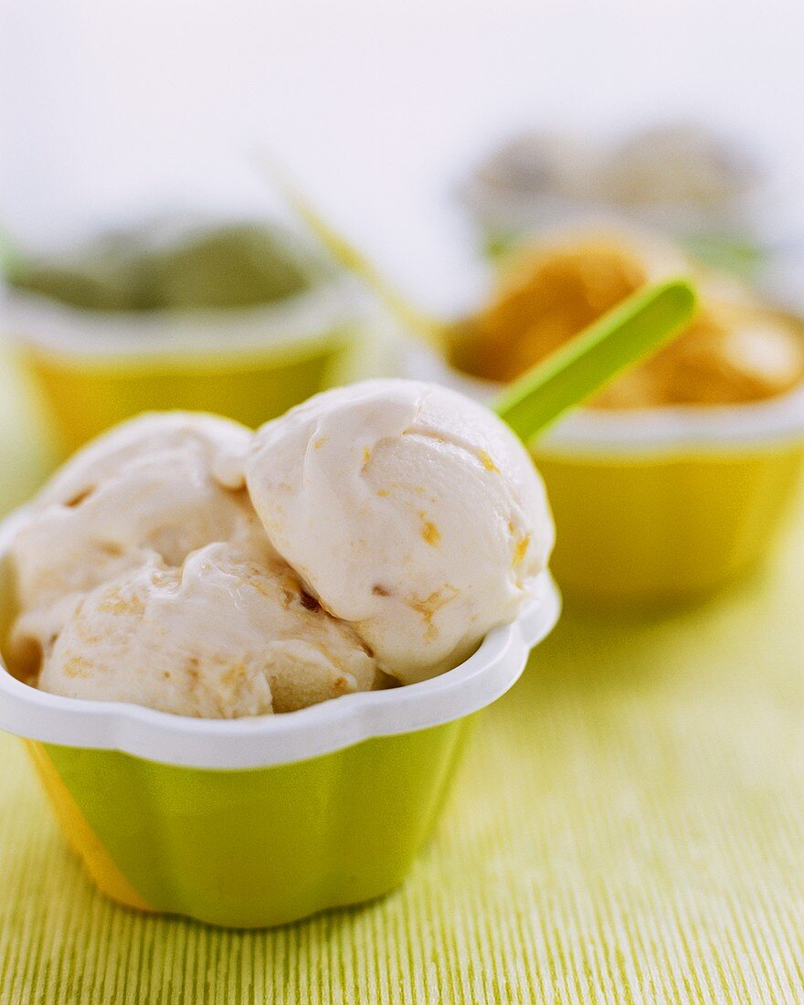 Orange and honey ice cream with raisins in a small bowl