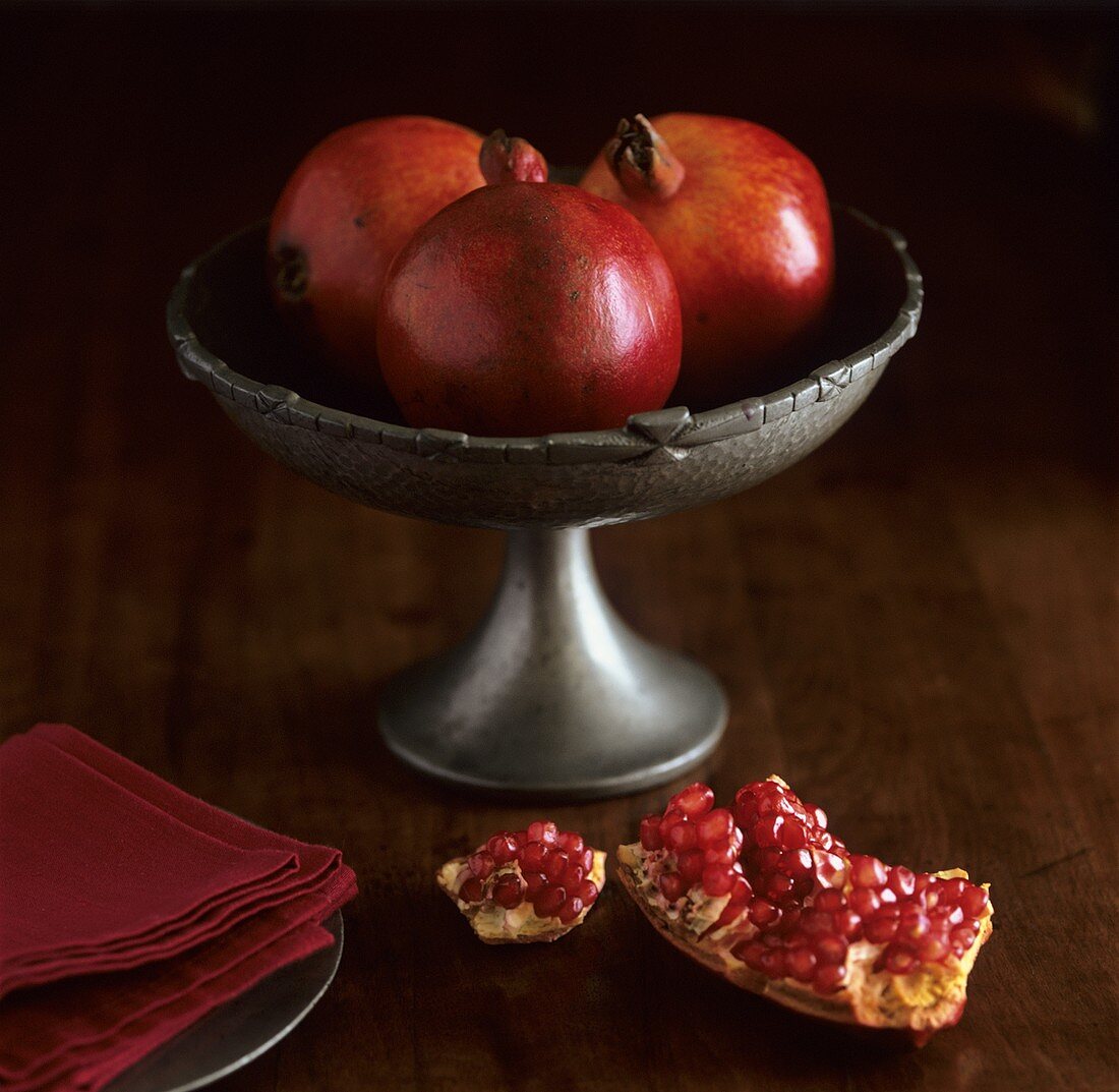 Three pomegranates in a bowl