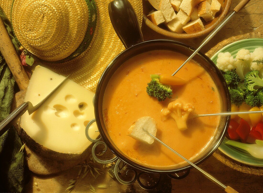 Dipping Vegetables and Bread into Cheese and Tomato Fondue