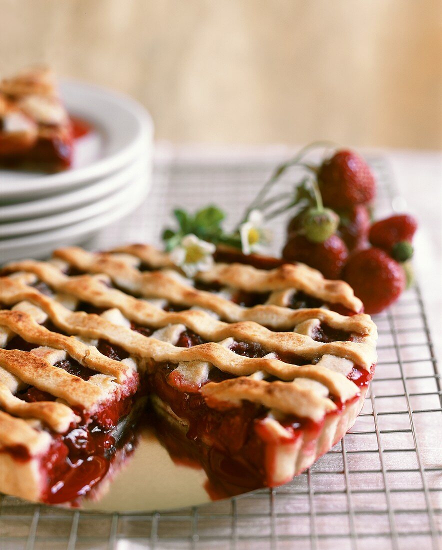 Strawberry tart with pastry lattice, a piece cut