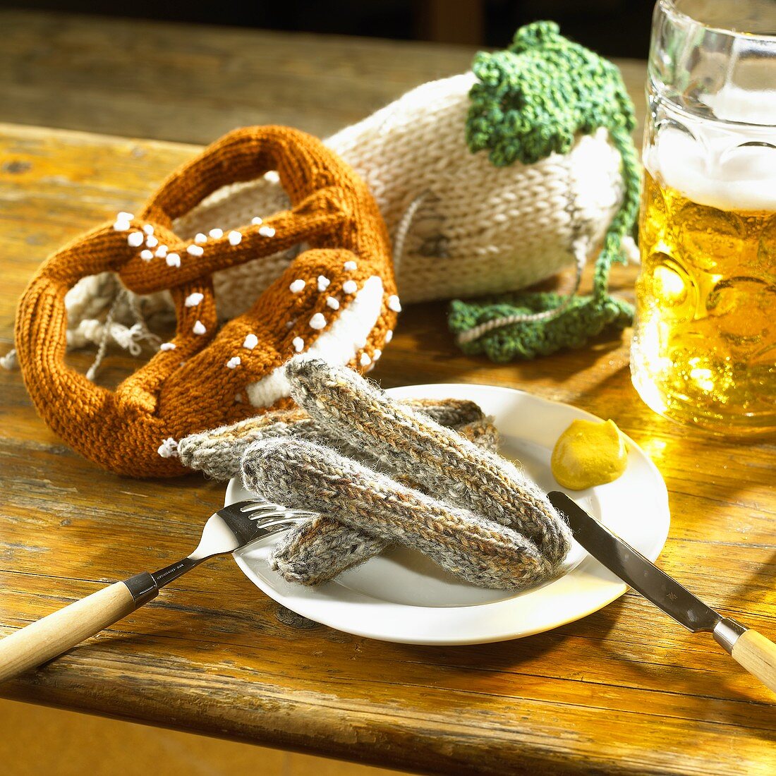 Knitted sausages, pretzel and radish with a litre of beer