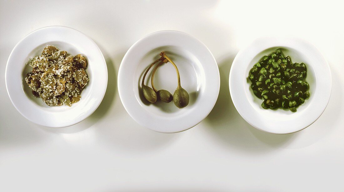 Three small bowls of capers