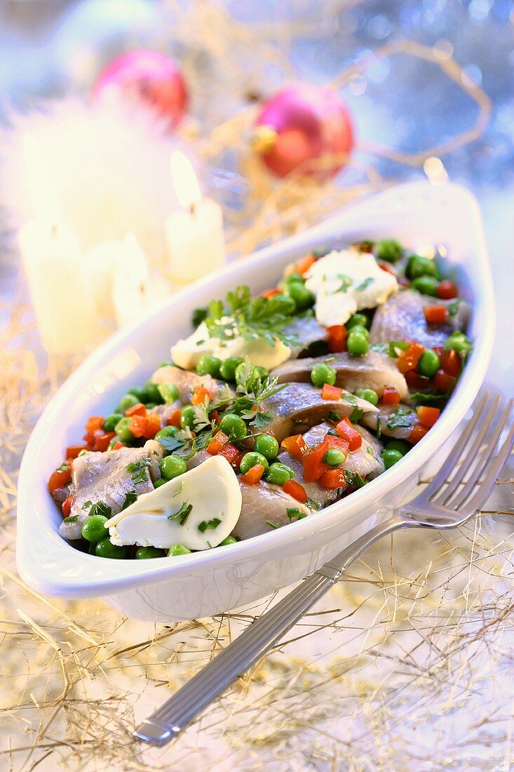 Herring salad with peas, diced peppers and spices