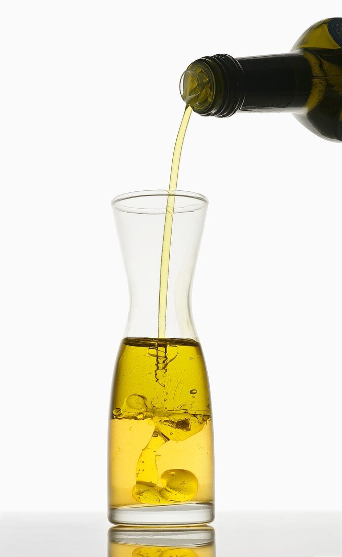 Oil being poured into vinegar