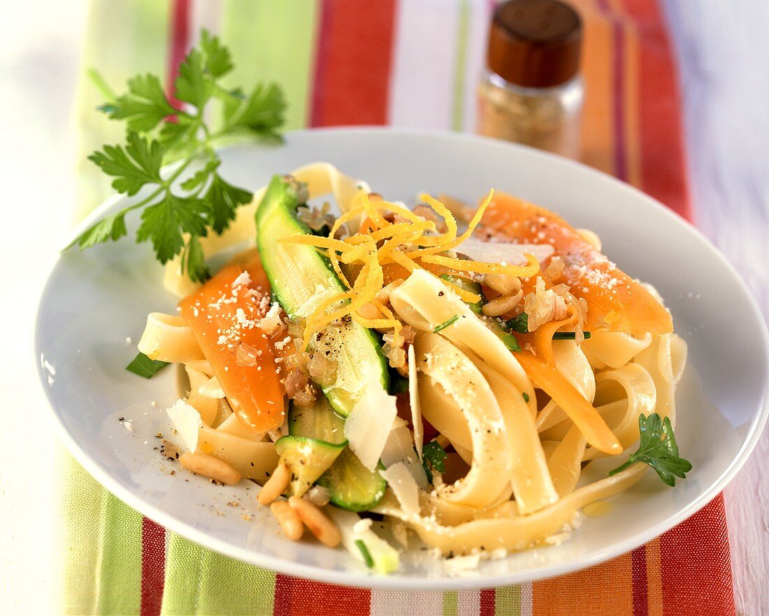 Ribbon pasta with vegetables and pine nuts