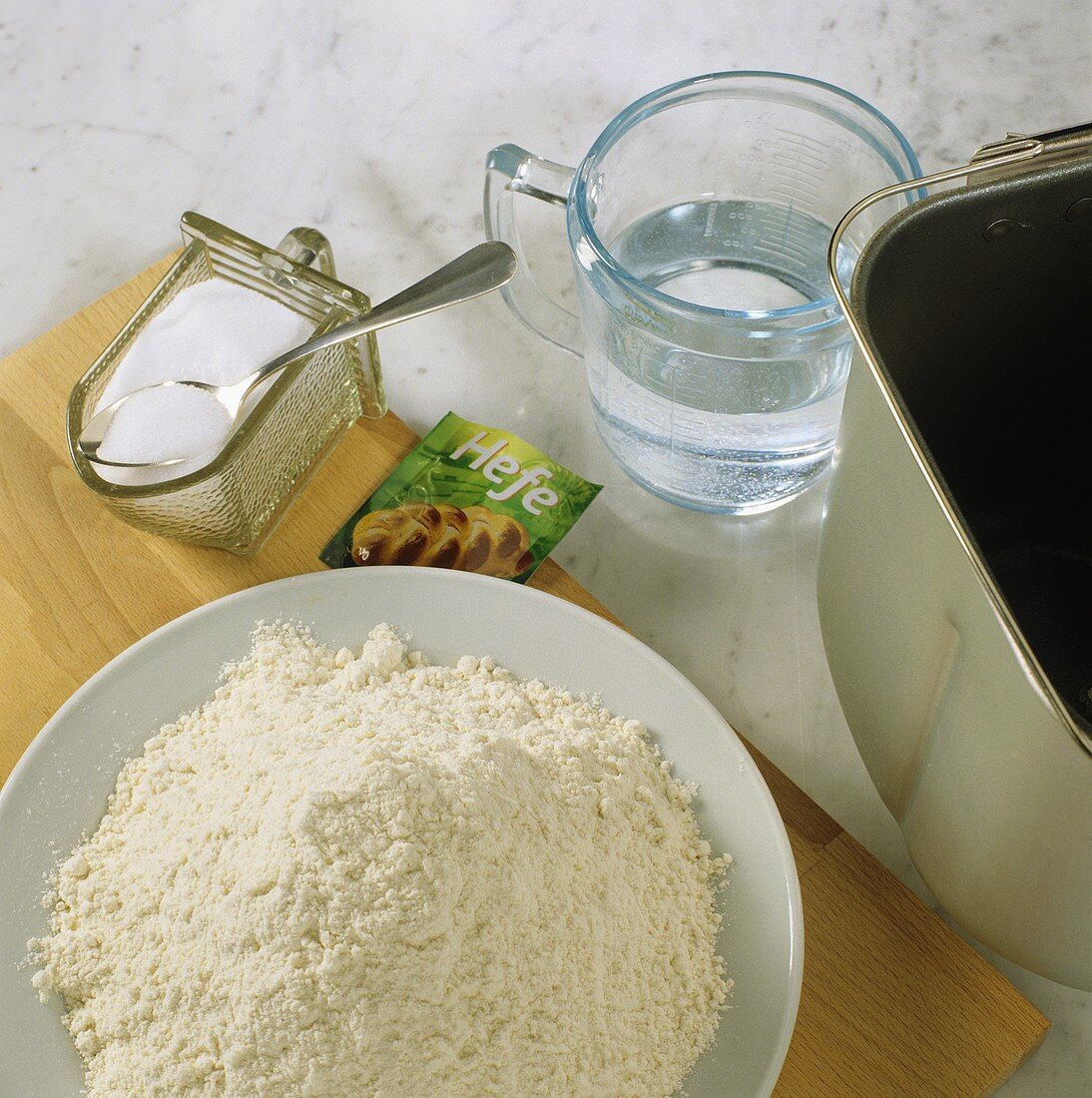 Ingredients for white bread dough (flour, yeast, salt & water)