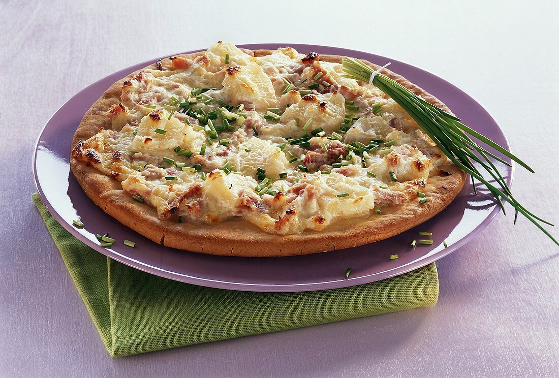 Ham, pineapple and cheese pizza with chives