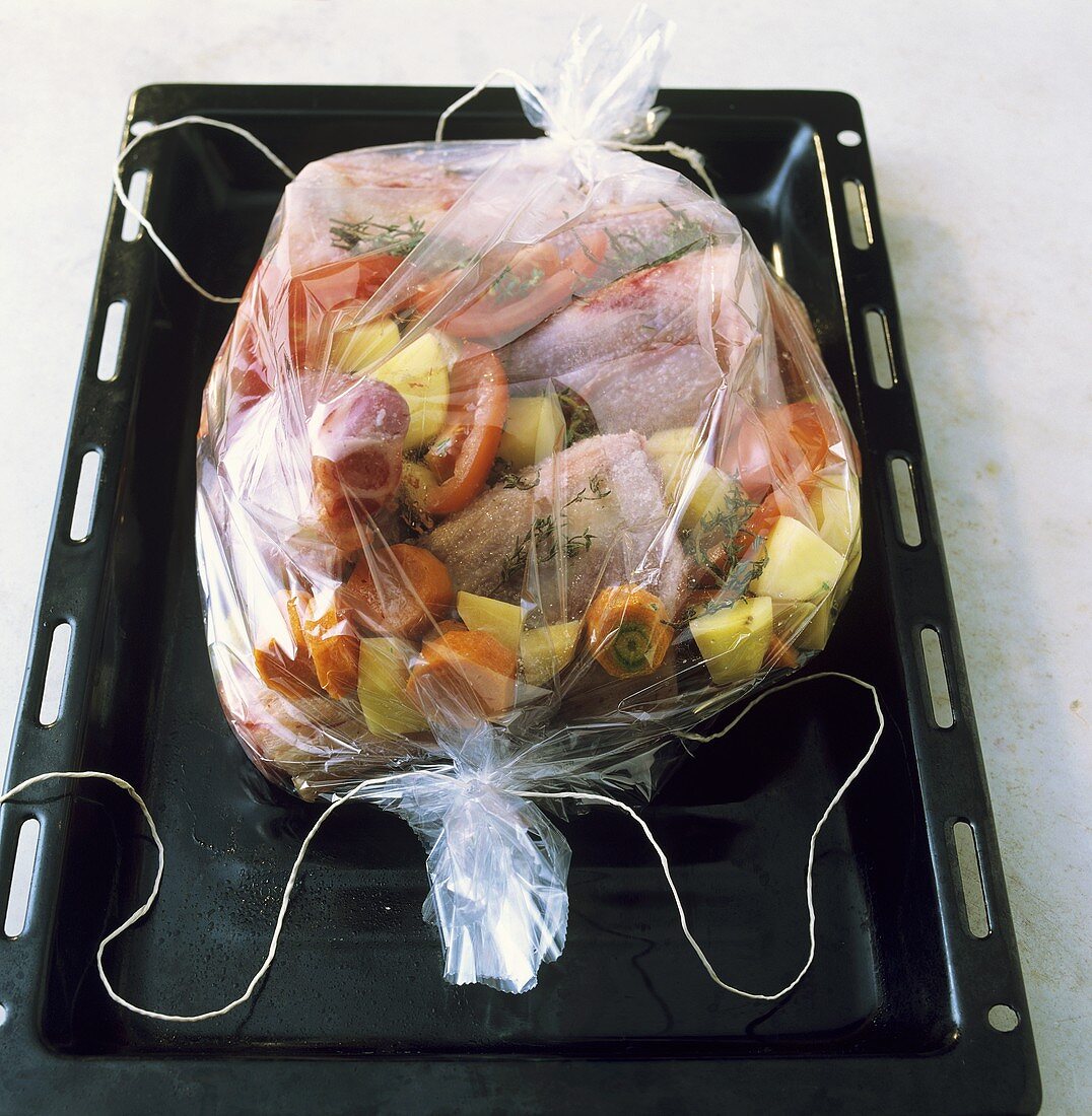 Meat and vegetables (ready to cook) in roasting sleeve