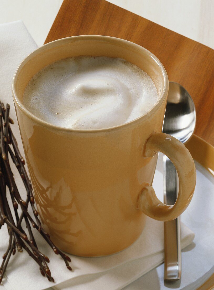 Melange (half coffee, half milk) in yellow cup