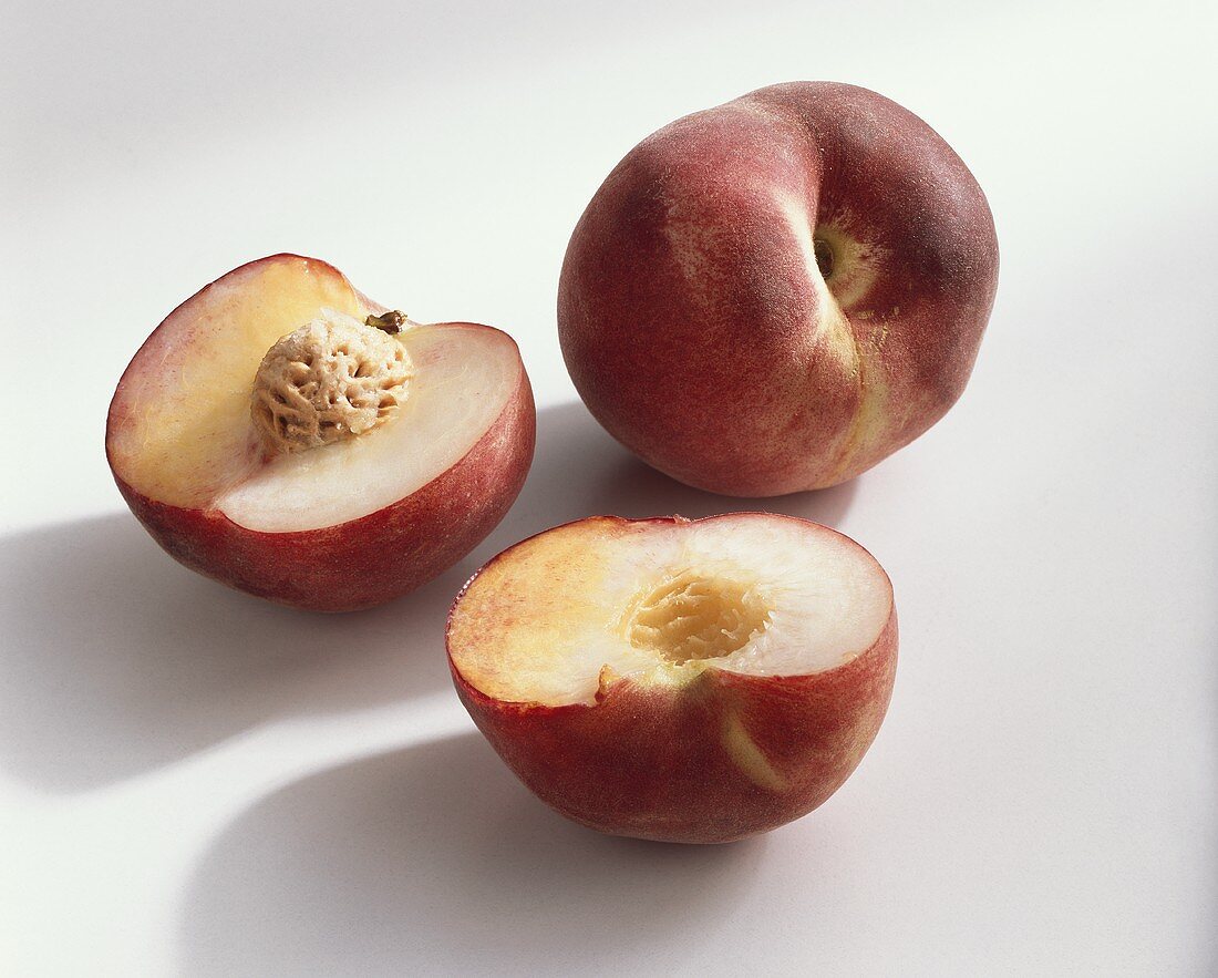 Peach, variety ‘September Sun’, whole and halved