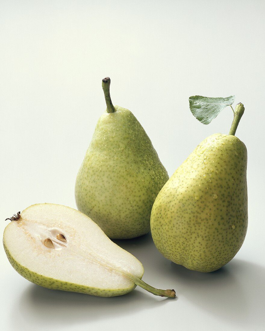 Pears (Pyrus communis), variety ‘Dr. Guyot’, whole and halved