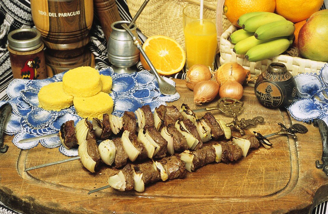 Grilled meat kebabs, corn cakes and mate (Paraguay)