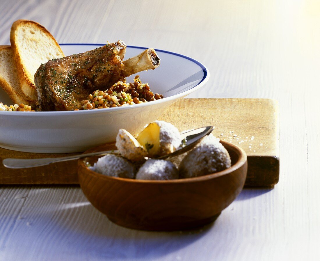 Braised lamb shanks with lentils, white bread, potatoes