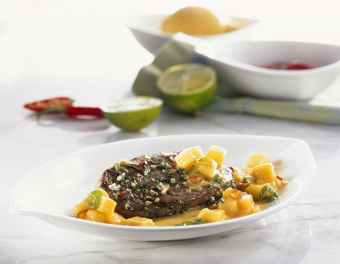 Grilled ostrich steak with mango and coconut sauce