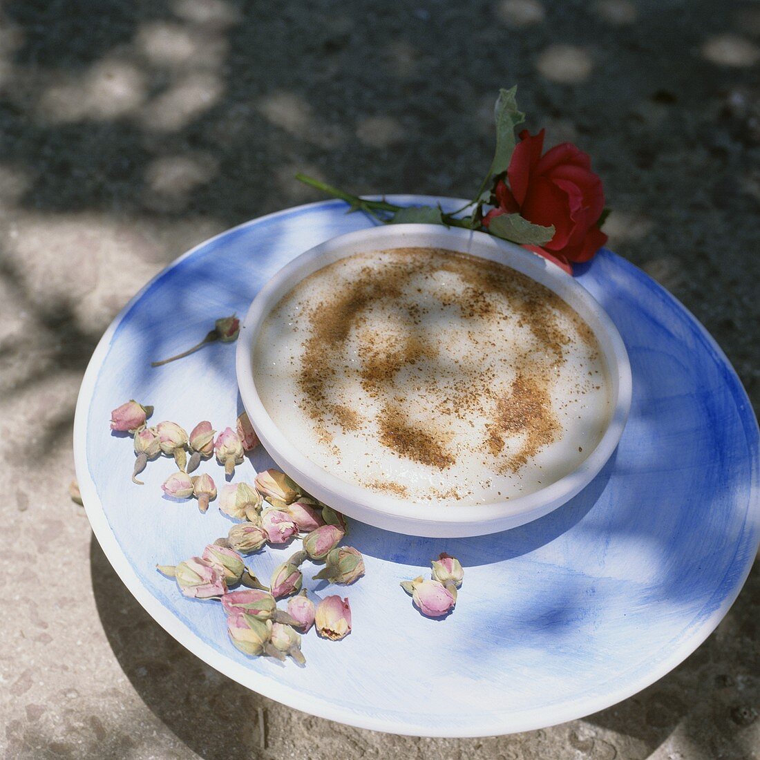 A bowl of cinnamon pudding decorated with flowers