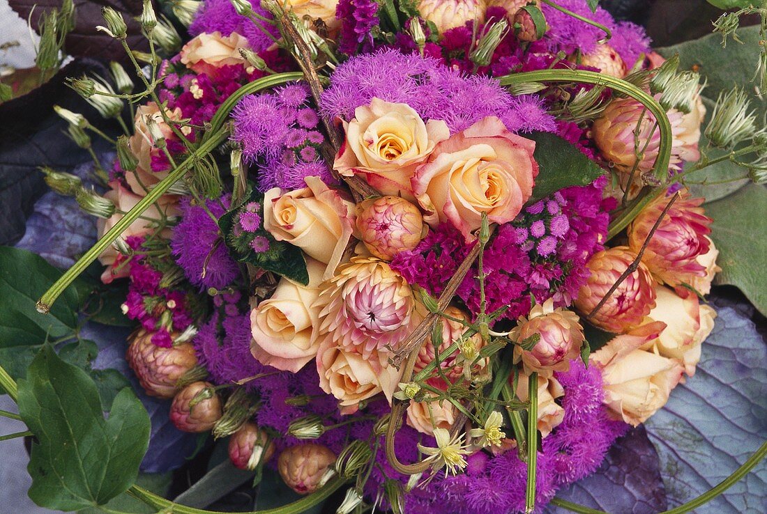 Small bouquet of Ageratum and roses from above