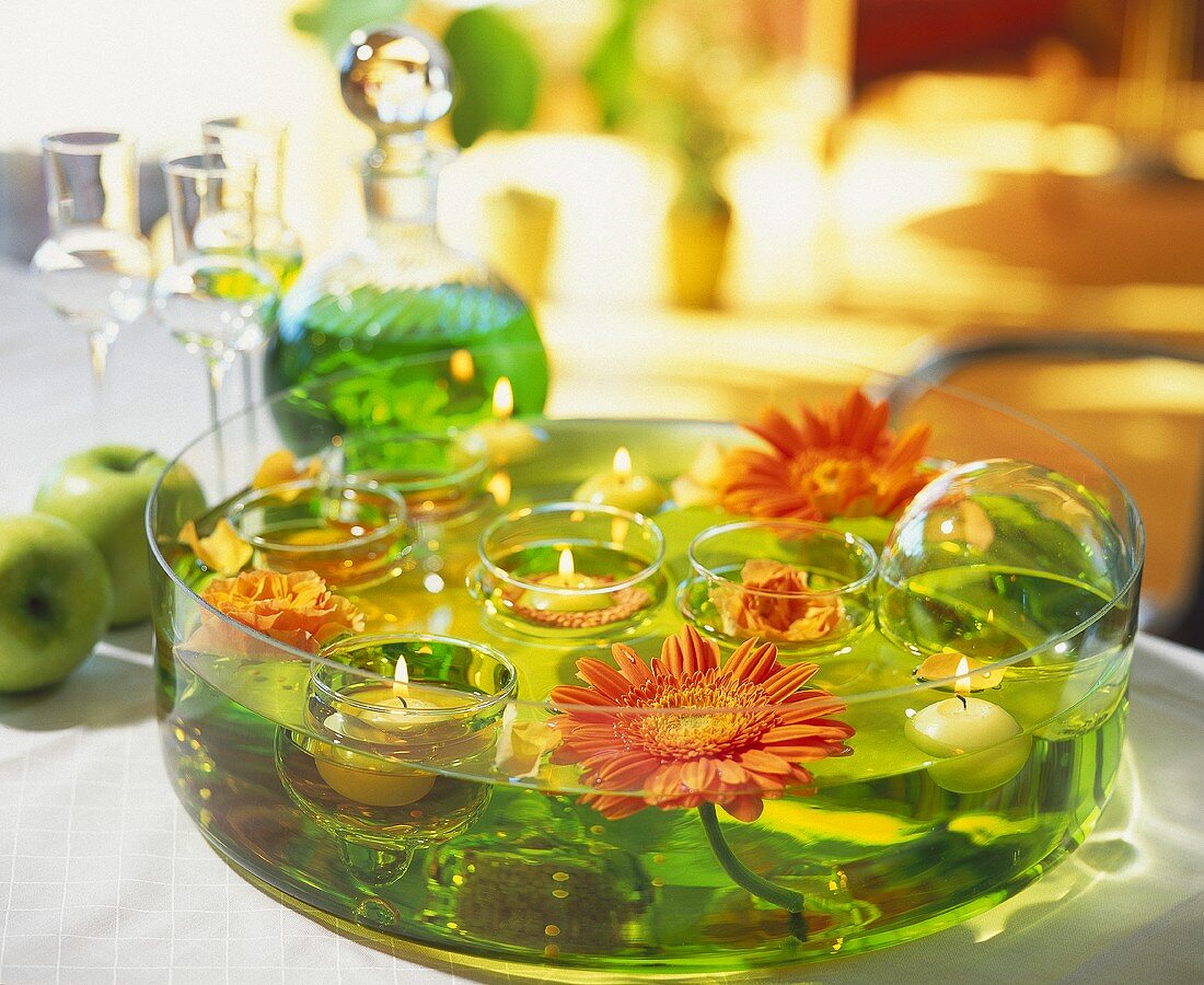 Glass bowl with floating Gerberas, floating candles & roses